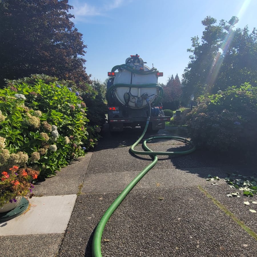 Septic service truck parked for a residential visit at an Abbotsford-area property.